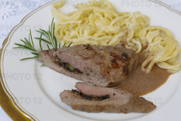 Swabian cuisine, lamb stuffed with prunes, rosemary, herbs, fillets arranged on plates,