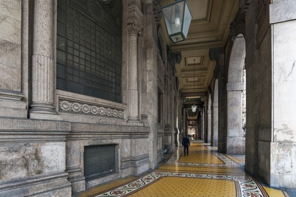 Arcaded walkway with mosaic floor from Palazzo della Borsa, built between 1907 and 1912, in Piazza