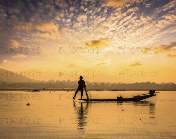 Myanmar travel attraction landmark, traditional Burmese fisherman sihouettes at Inle lake on