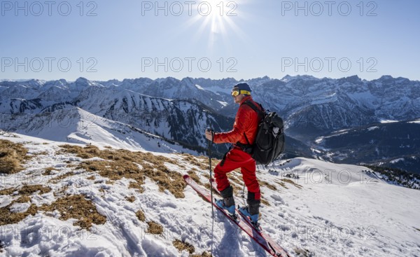 Ski tourers at the summit of Schafreuter, view of snowy mountain panorama, Karwendel, Tyrol,