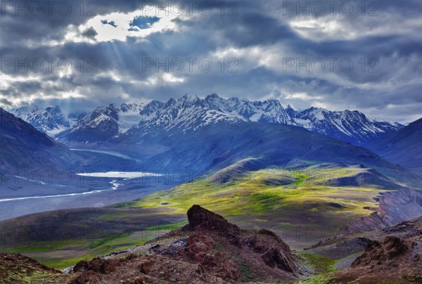 Himalayan landscape near Chandra Tal lake with sun rays coming through clouds. Himachal Pradesh,