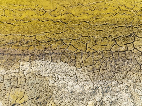 Mineral-rich cracked earth at the bank of the Rio Tinto (Red river), aerial view, drone shot,
