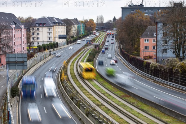 Motorway A40, Ruhrschnellweg, skyline of the city centre of Essen, exit Essen-Huttrop, track bus