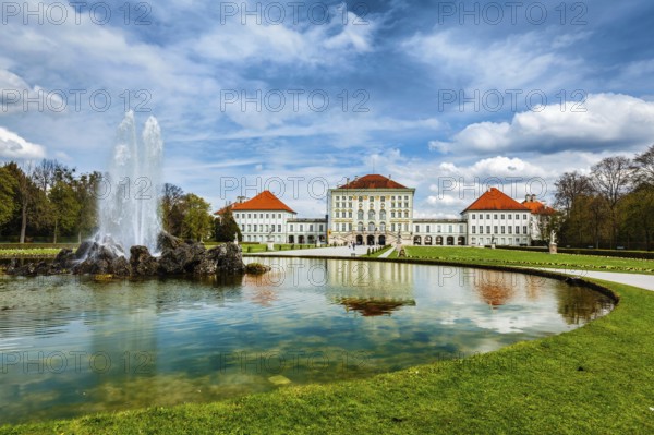Fountain in Grand Parterre (Baroque garden) and the rear view of the Nymphenburg Palace. Munich,