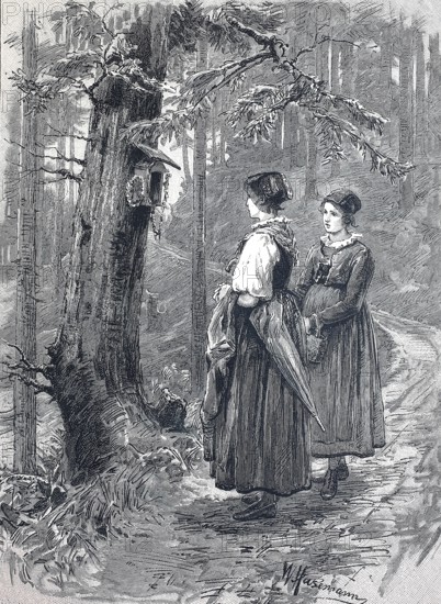 Two woman standing in front of a birdhouse by a tree on a path in the Black Forest, around 1890,