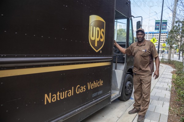 New Orleans, Louisiana - A United Parcel Service driver and his natural gas powered 'package car'