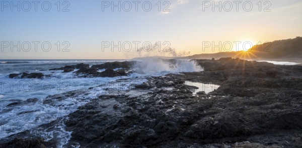 Waves crashing against rocks, Playa Cocalito, coastal landscape at sunset, sun star, Pacific coast,