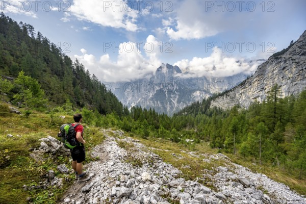 Mountaineer descending via the Ofental valley, mountain peak of the horse-rider Alpe behind,