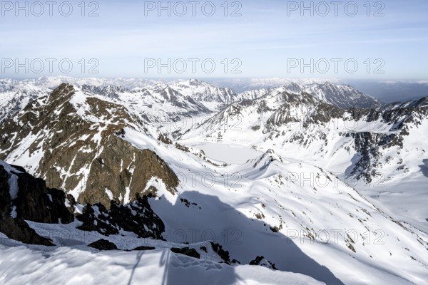 View from the summit of the Sulzkogel to Speicher Finstertal, mountain panorama in winter, with