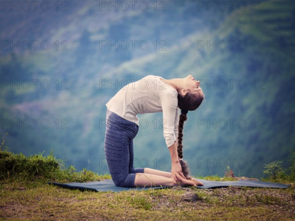 Yoga, outdoors young beautiful slender woman yoga instructor doing camel pose Ustrasana asana
