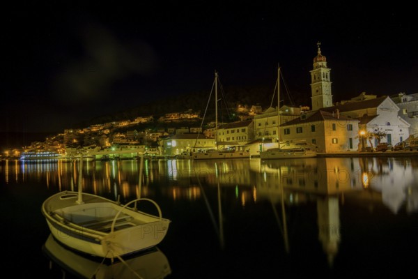 Church of St. Jerome of Stridon with rowing boat and sailboats at night, Pucišca, Split-Dalmatia