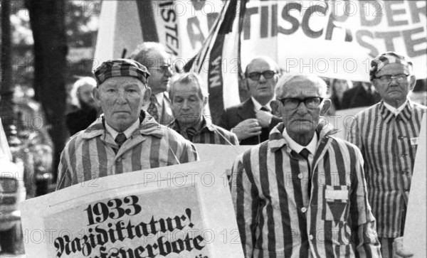 Nazi victims, some in concentration camp uniforms, demonstrated against the occupational bans