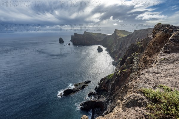 Red cliffs and rocks in the sea, coastal landscape with dramatic sky, Ponta de São Lourenço,