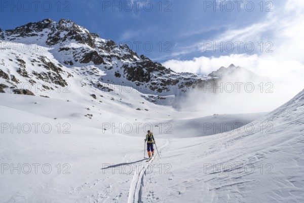Ski tourers in a wintry mountain landscape, ascent to Porta d'Es-cha, Grisons Haute Route ski tour,