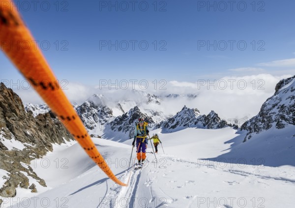 Ski tourer with rope, rope team on the Vadret da Porchabella glacier on the ascent to the summit of