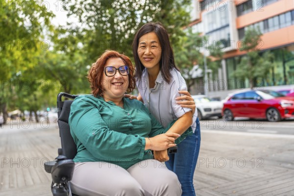 Portrait of a happy caucasian adult woman with disability sitting on electric wheelchair and her