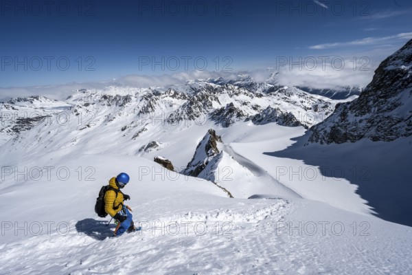 Mountaineer with ice axe and crampons, ascent through steep snowfield to Piz Kesch or Piz d'Es-cha