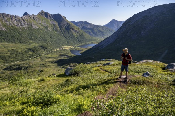Mountaineers on a hiking trail to the summit of Rundfjellet, mountain landscape and valley with