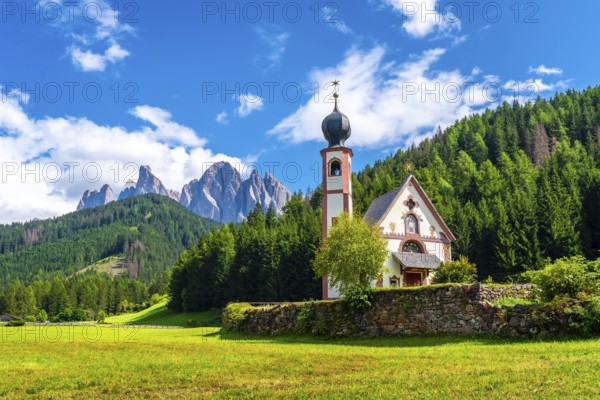Scenic summer landscape with st. Magdalena church in the idyllic valley of val di funes, surrounded