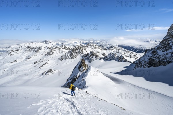 Mountaineer with ice axe and crampons, ascent through steep snowfield to Piz Kesch or Piz d'Es-cha