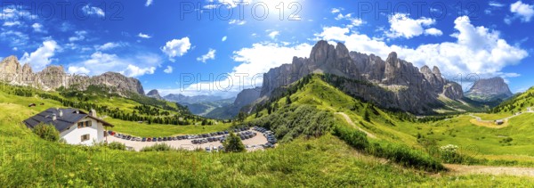 Breathtaking panorama of the dolomites in summer, showcasing lush green valleys, rugged peaks, and