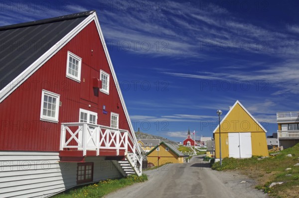 Colourful Scandinavian houses along a quiet street under a blue sky, old town of the capital of