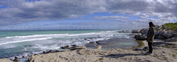 Man standing on the coast watching the sea, De Hoop Nature Reserve, nature reserve near Struisbaai,