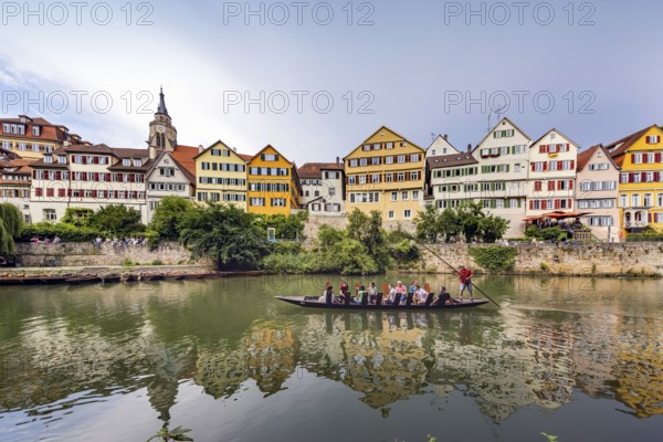 Neckarfront Tübingen with punt on the Neckar. Postcard motif with historic buildings and collegiate