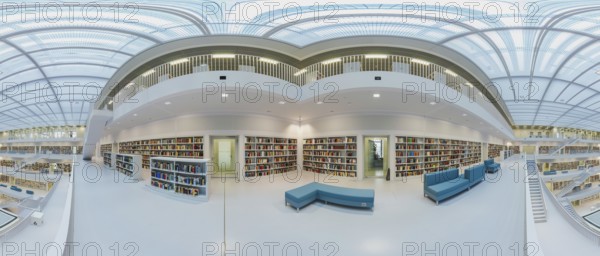 Modern library with glass roof and white stairs, surrounded by bookshelves in a bright open space,
