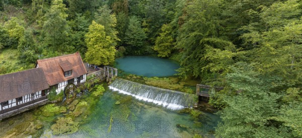 Blautopf Blaubeuren with industrial monument Hammerschmiede, source of the little river Blau in a