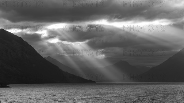Black and white image of sunbeams and light mood at sunset at Lago Huechulafquen, Lanin National