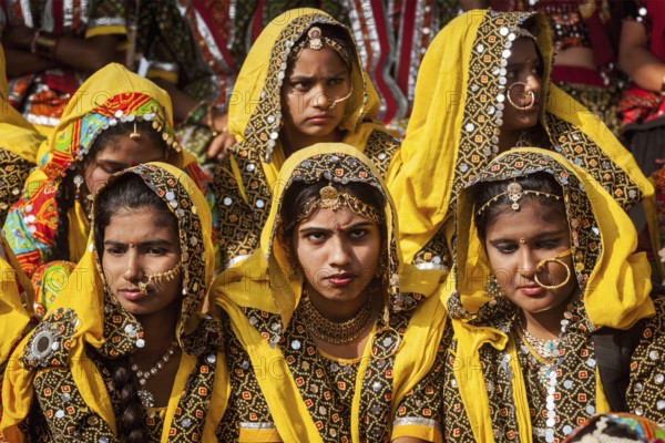 PUSHKAR, INDIA, NOVEMBER 21, 2012: Unidentified Rajasthani girls in traditional outfits prepare for