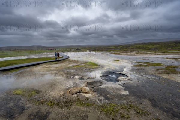 Tourists on a logging road between hot springs, Hveravellir geothermal area, Icelandic Highlands,