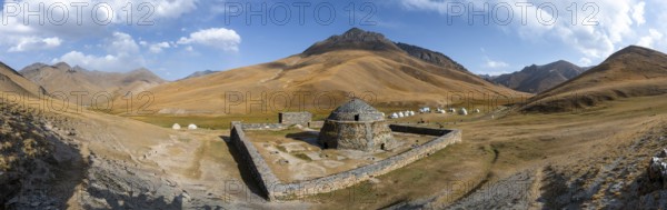 Historic caravanserai Tash Rabat from the 15th century, with yellow hills, Atbashy district in the