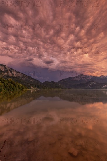 Stormy atmosphere, mountains reflected in lake, Lake Kochel, Alpine foothills, Bavaria, Germany,