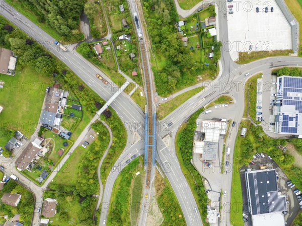 Aerial view of a road crossing with railway bridge in urban surroundings, track construction, rail