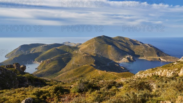A clear picture of a bay with mountainous surroundings and blue sky on the coast, southern tip,