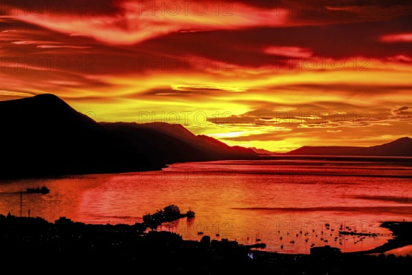 Ushuaia, Tierra del Fuego, Argentina, Glowing red sunrise over the Beagle Channel, the Beagle