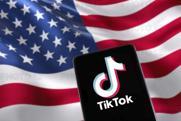 TikTok logo from China with USA United States of America flag social media on a mobile phone in