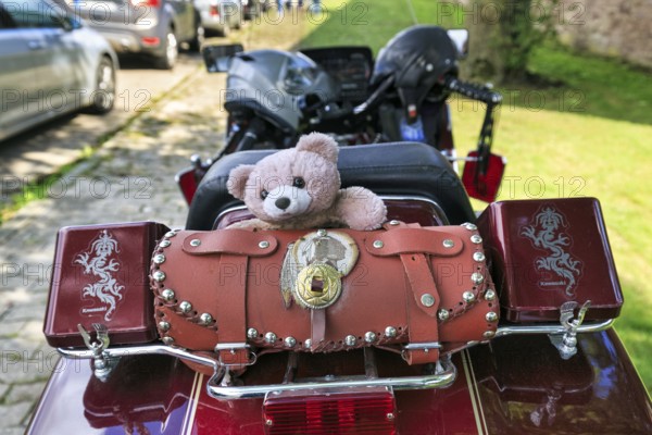 Motorbike with panniers and teddy bear parked at the roadside, Kawasaki, retro, Lower Saxony,