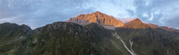 Panorama, rocky mountain peak Porze and green mountain landscape with river valley at sunrise,