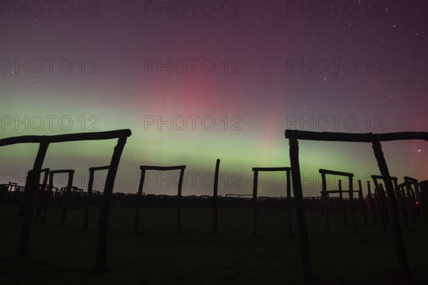Northern lights (aurora borealis) over the ring sanctuary of Pömmelte, prehistoric circular ditch