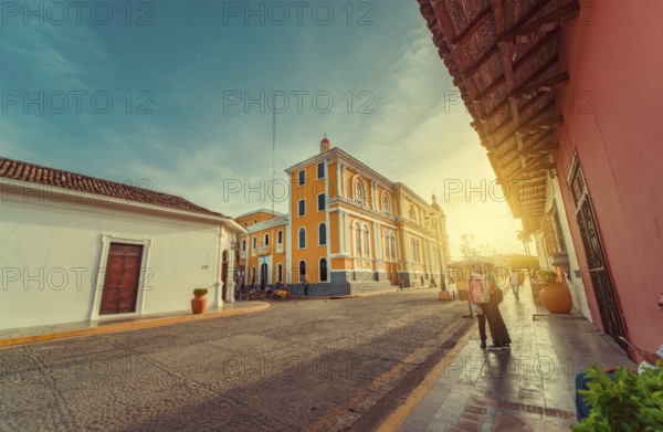 People walking through the cathedral of Granada that leads to La Calzada street. Granada, Nicaragua