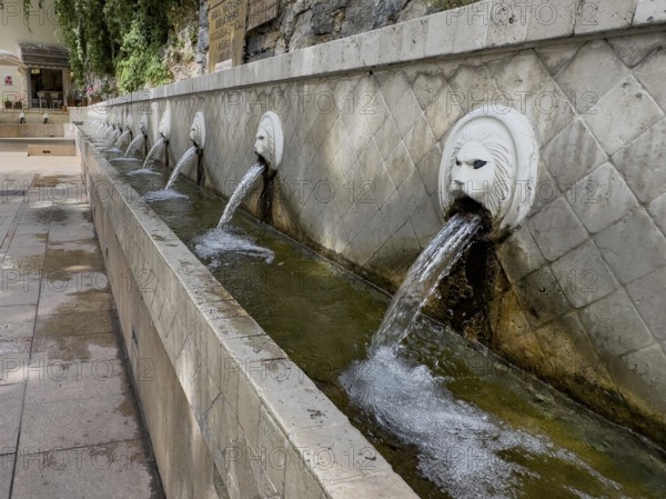 Partial view of lion fountain Venetian fountain Kefalovrisi with 25 gargoyles in the shape of