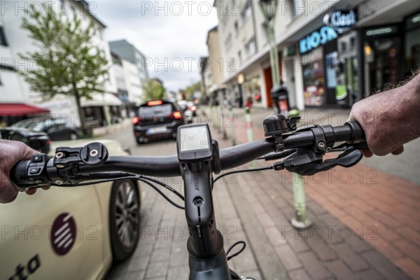Cycling in the city, inner-city street, cycle lane, bicycles have priority, two-lane traffic with