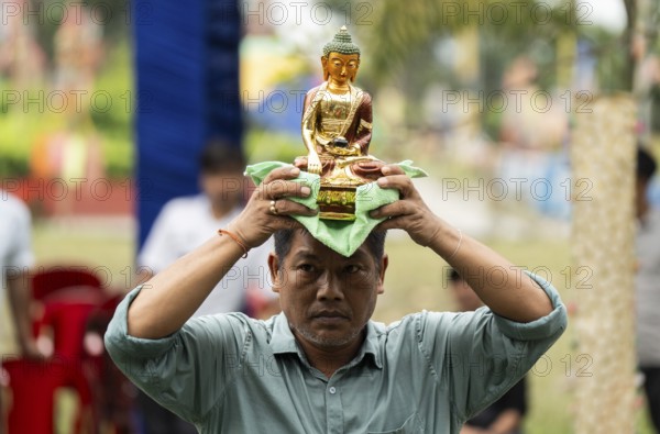 NAMSAI, INDIA.- APRIL 16: A devotees carries the idol of Lord Buddha as he celebrate the vibrant