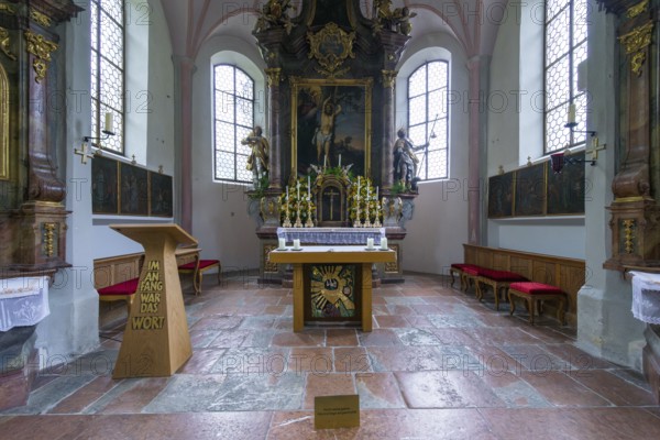 Parish church of St Sebastian with richly decorated altar, statues of saints and paintings, framed