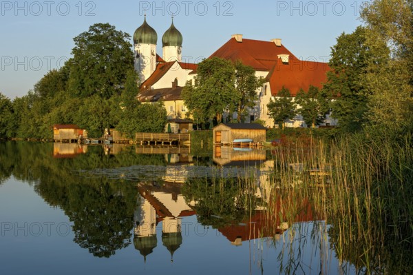 Romanesque Benedictine Abbey Seeon Monastery, monastery church St. Lambert with reflection in the