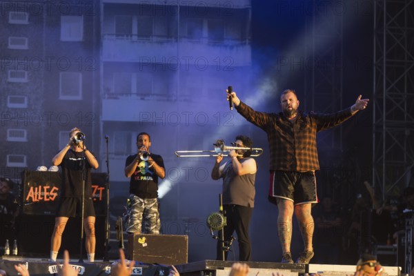 Monchi (Jan Gorkow, right), singer of Feine Sahne Fischfilet and members of the band Panteon