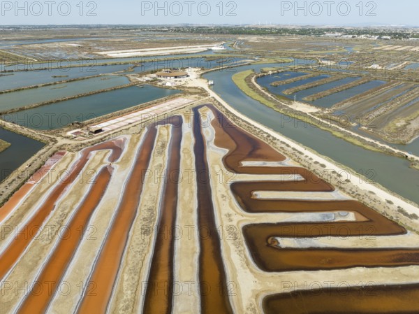 Saline ponds at the salt works near Chiclana de la Frontera. The orange-red colour depends on the